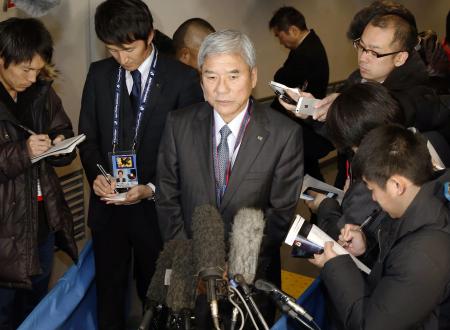 報道陣に囲まれ八百長疑惑の質問に重い口を開く日本サッカー協会の大仁邦弥会長(中央)(2014年12月18日、共同)