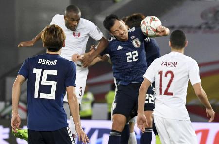 日本―カタール 後半、自陣ゴール前で競り合う吉田(上右)。VARでハンドの判定=アブダビ(AP=共同)