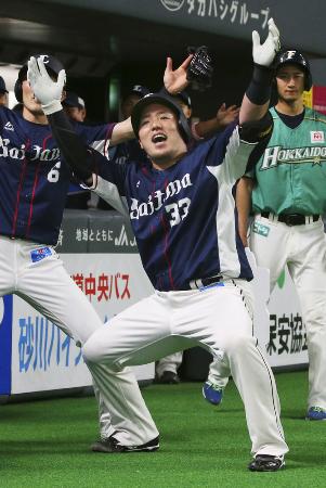 5月12日の日本ハム戦で通算100本塁打を放ち、ベンチ前でポーズを決める西武・山川=札幌ドーム
