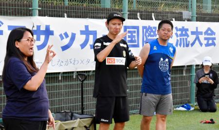 交流キャンプで手話を使いコミュニケーションを取るデフサッカー男子日本代表元監督の植松隼人さん(中央)=8月、東京都品川区
